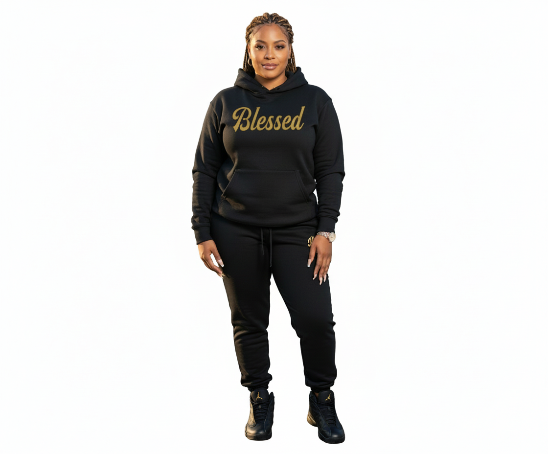 Woman wearing a black hoodie with 'Blessed' text by a waterfront