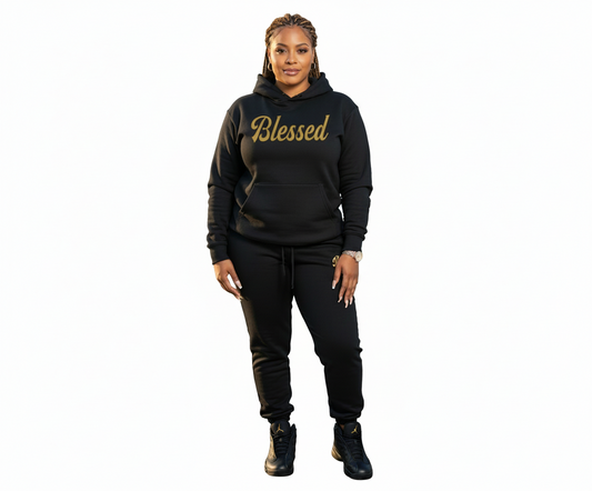 Woman wearing a black hoodie with 'Blessed' text by a waterfront