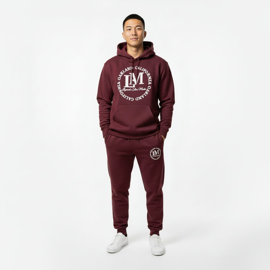 Maroon hoodie and sweatpants set with a logo on a white background